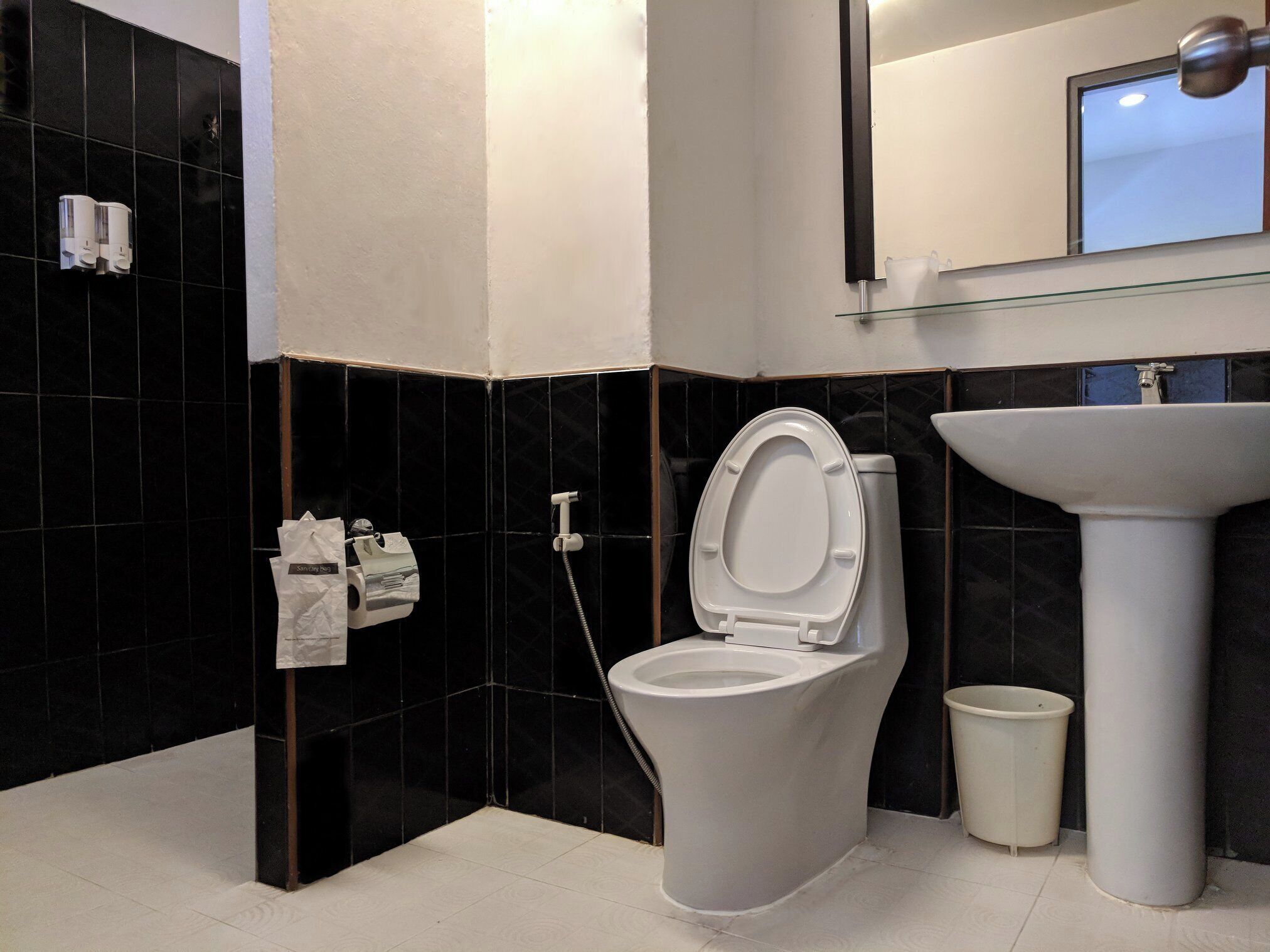 A modern bathroom with a toilet, bidet, and sink.