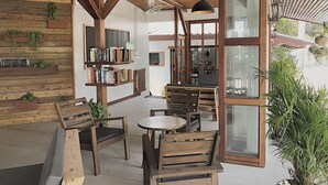 Un interior de madera con comedor, estanterías y plantas en macetas.