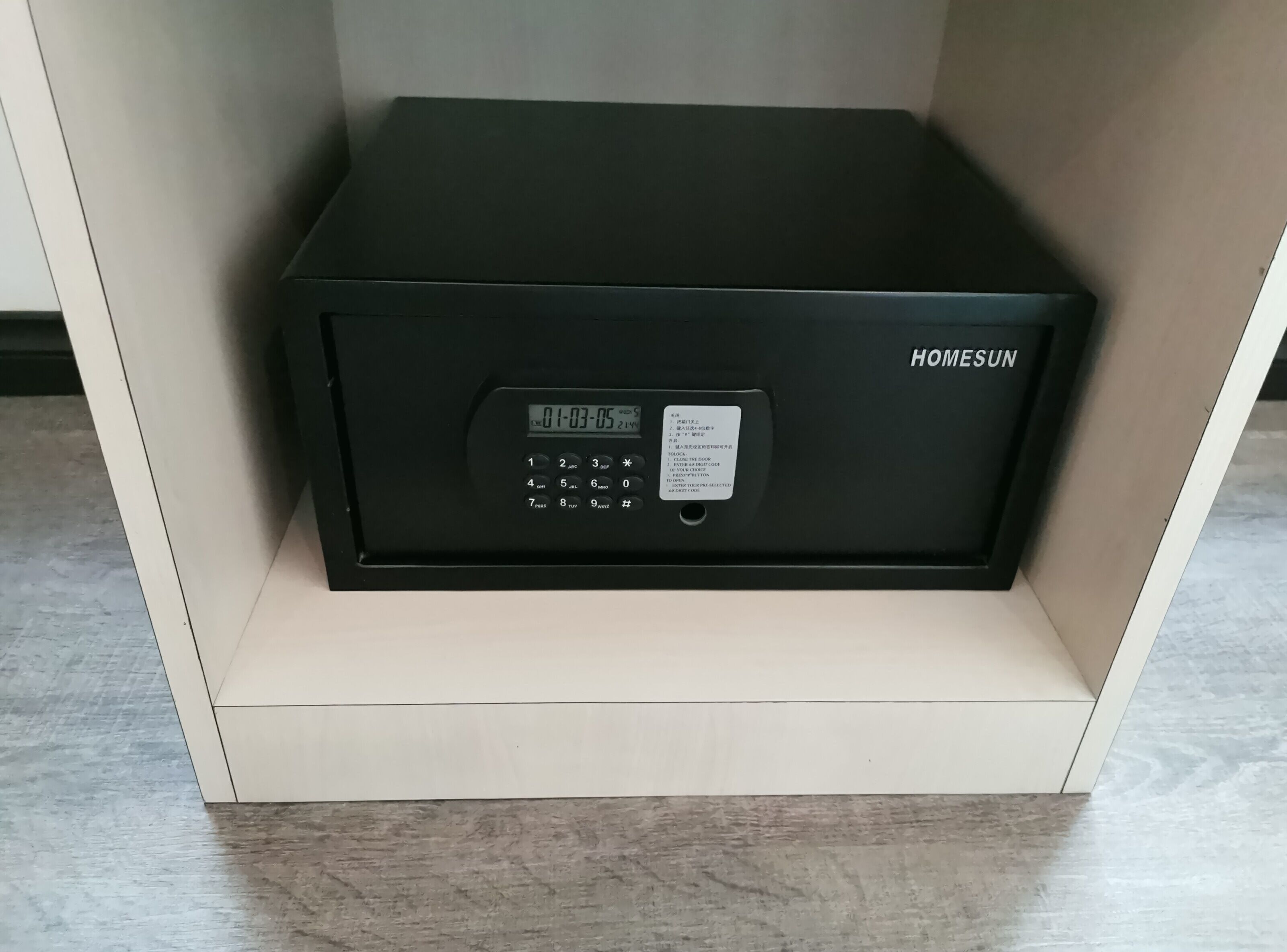 A black safe with a keypad and a label reading "HOMESUN."