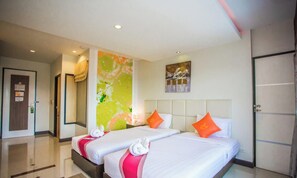 A hotel room with two beds, a large abstract painting, and a door with a sign. - Ayara Grand Palace Hotel (Phitsanulok)