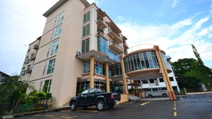 A multi-story hotel with a modern design, featuring a central atrium and balconies. - Lanvin Hotel (Kota Kinabalu)