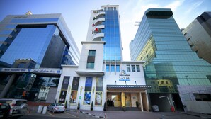 A hotel with a modern facade, a prominent entrance, and a visible sign indicating it is the RAVIZ Center Point Hotel. - Raviz Center Point Hotel (Dubai)