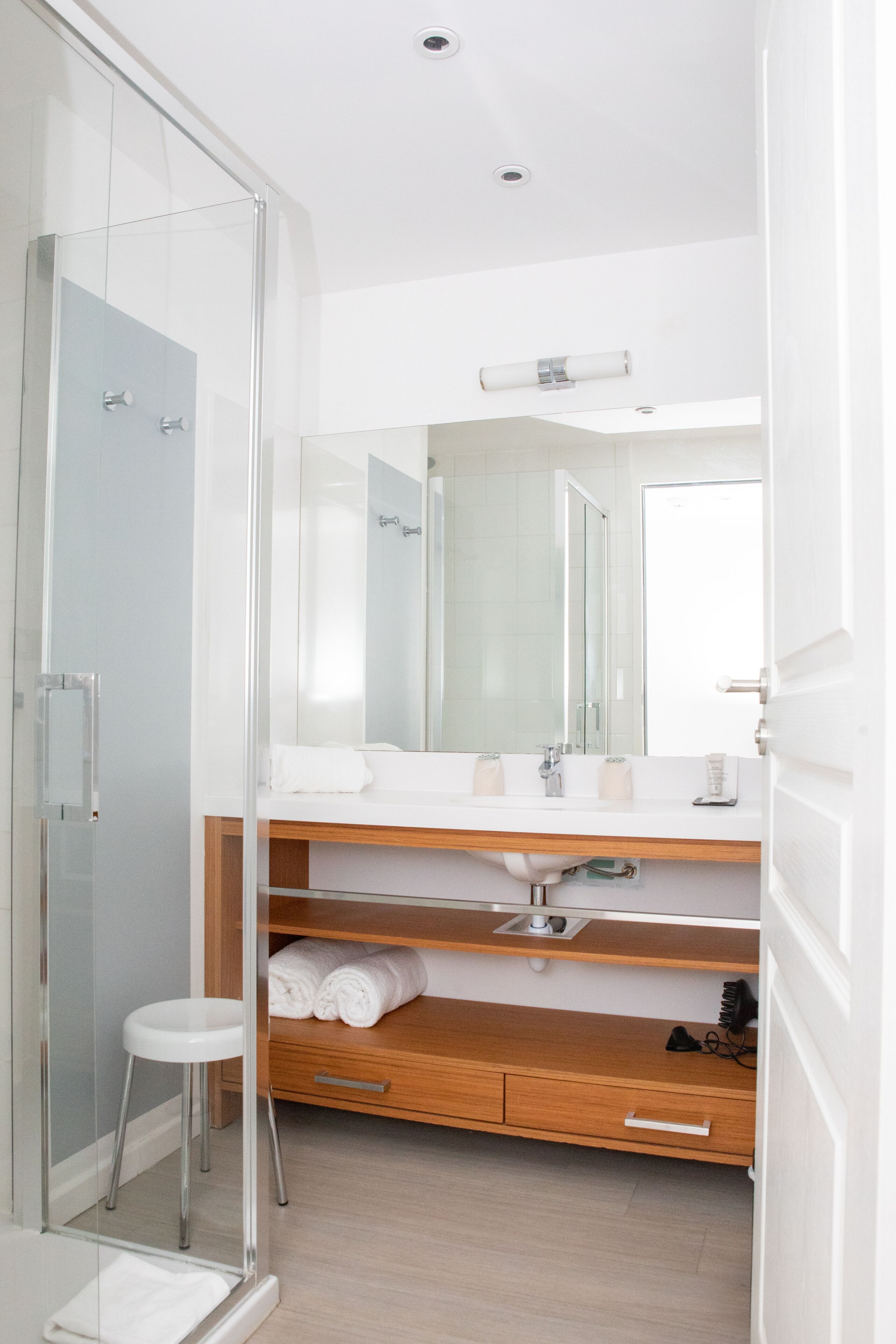 shower, hair dryer, slippers, towels