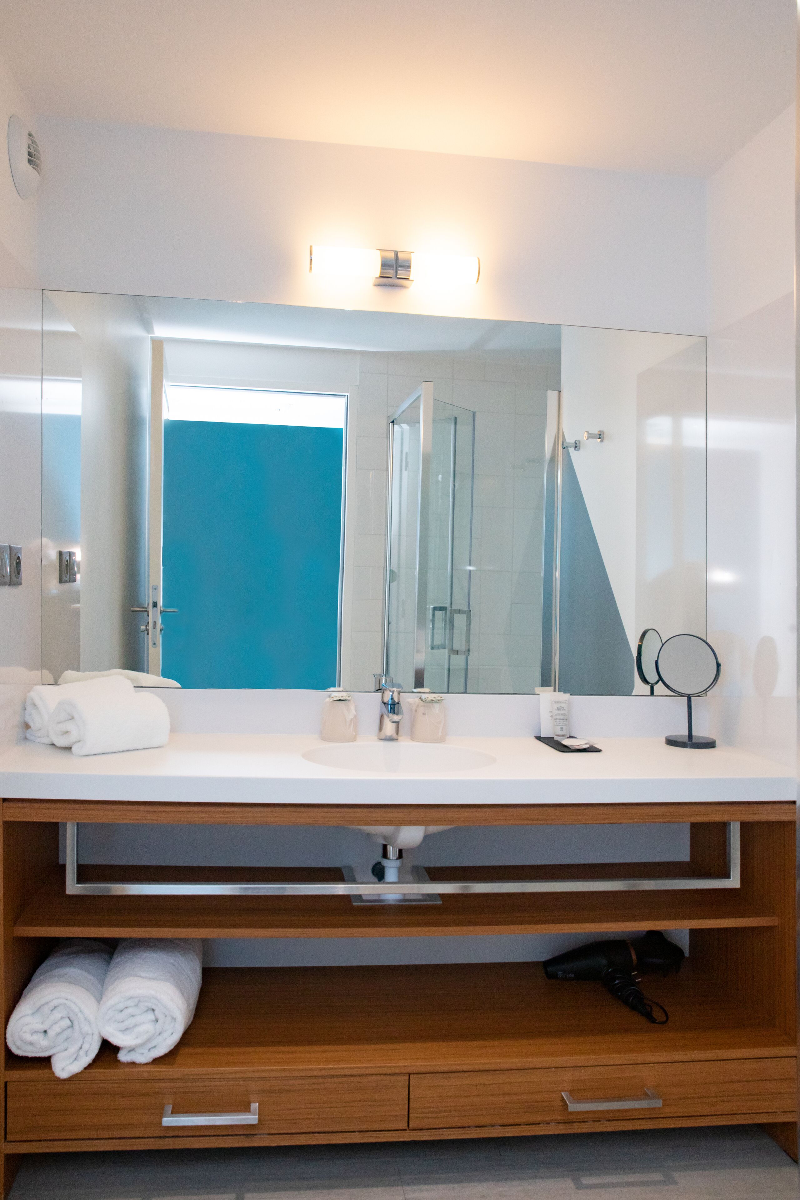 shower, hair dryer, slippers, towels