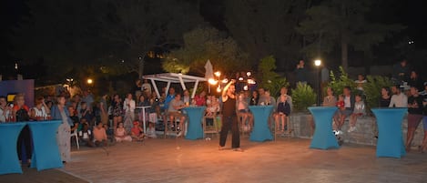 An outdoor event with a stage and audience.