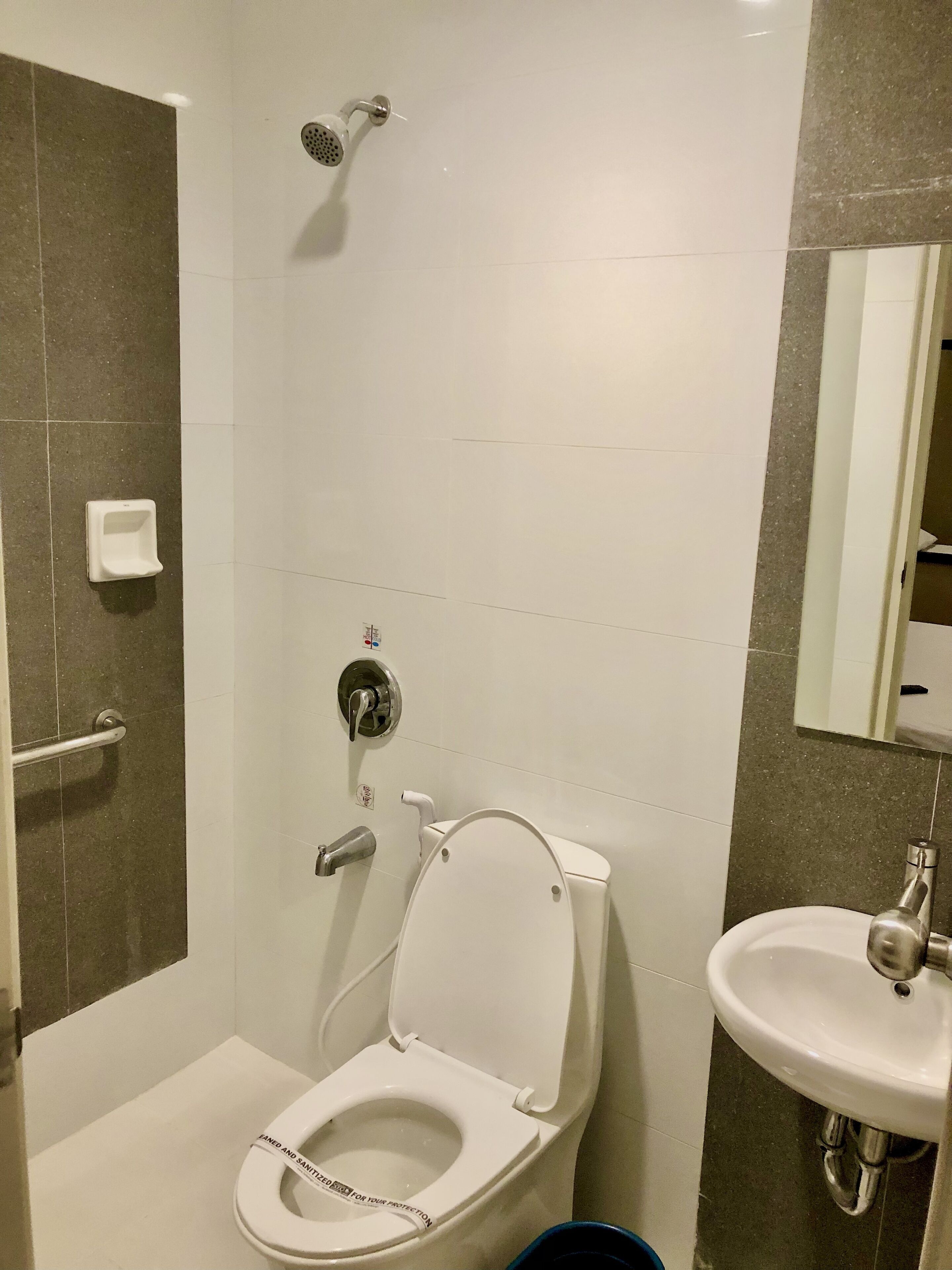 A modern bathroom with a toilet, bidet, and sink.