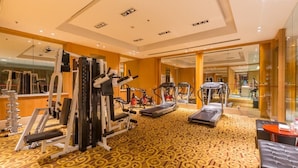 A gym with various exercise equipment, including treadmills and weight machines, and a patterned carpet. - Shuguang International Hotel Nanjing (Nanjing)