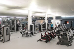 A gym with various exercise equipment, including treadmills and weight machines.