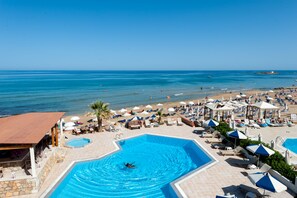 A resort with a swimming pool, beach area, and lounge chairs. - Laplaya Beach (Hersonissos)