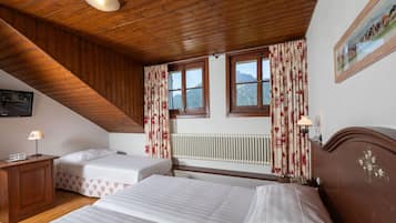 Family Triple Room | Minibar, in-room safe, individually decorated, desk