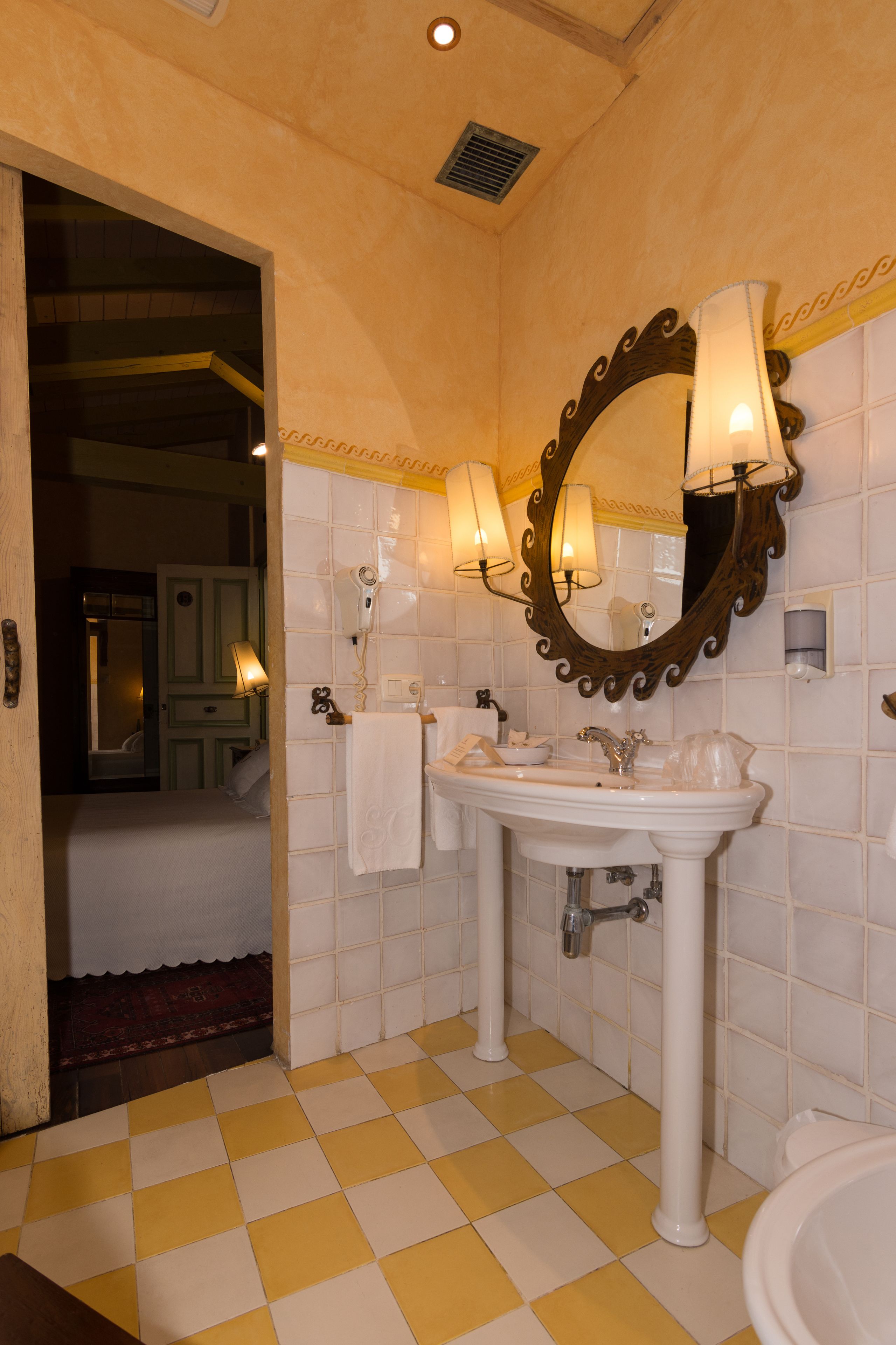 A bathroom with two sinks, a large mirror, and a towel rack.