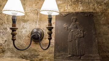 A wall-mounted light fixture with two lamps and a relief sculpture.