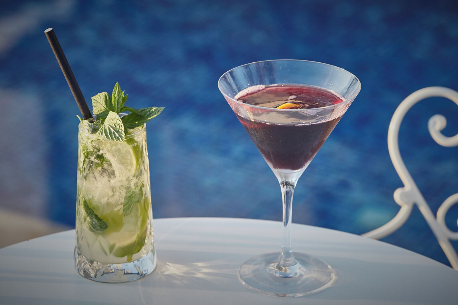 Two drinks on a table with a blue background.