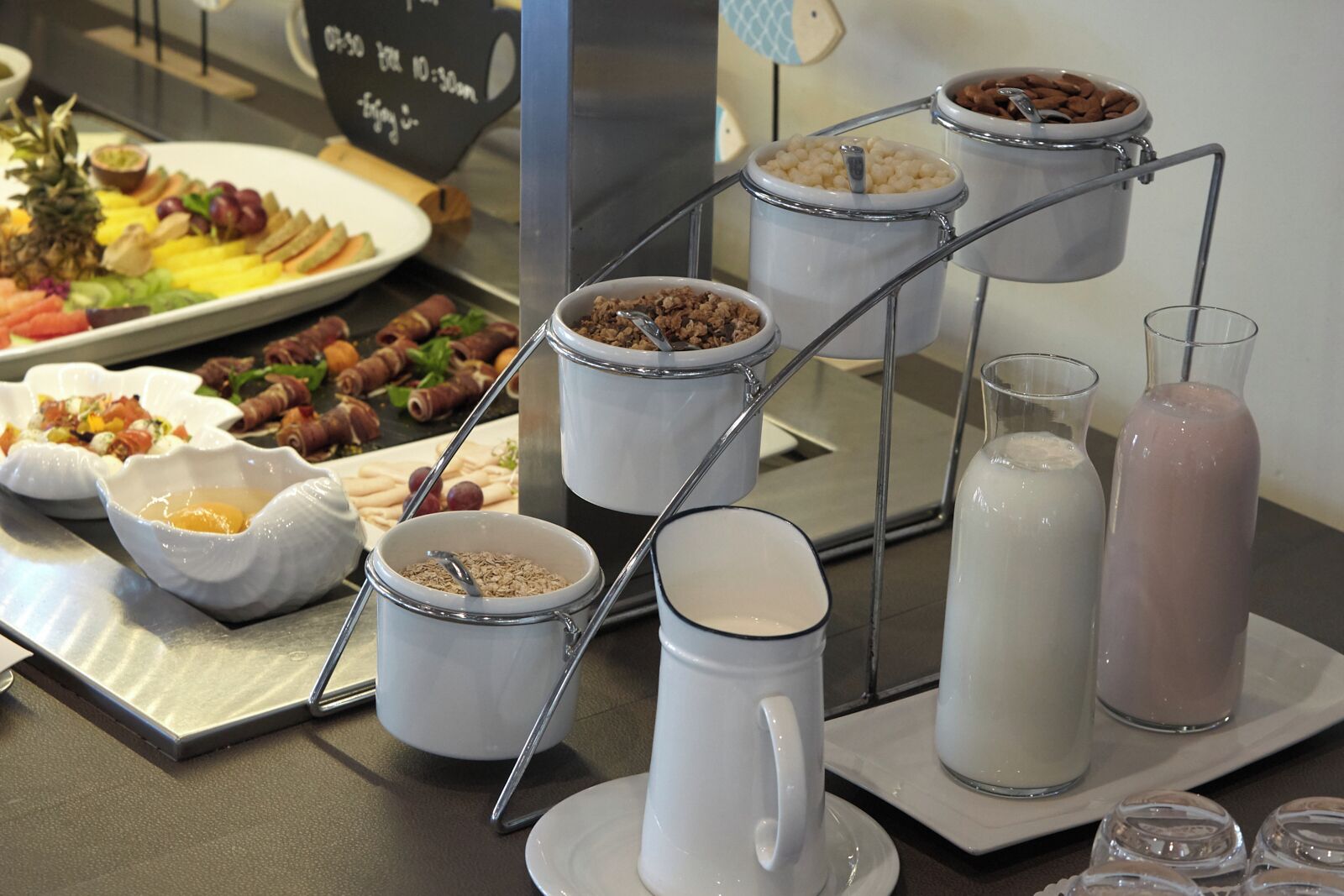A breakfast buffet with various food items and beverages.