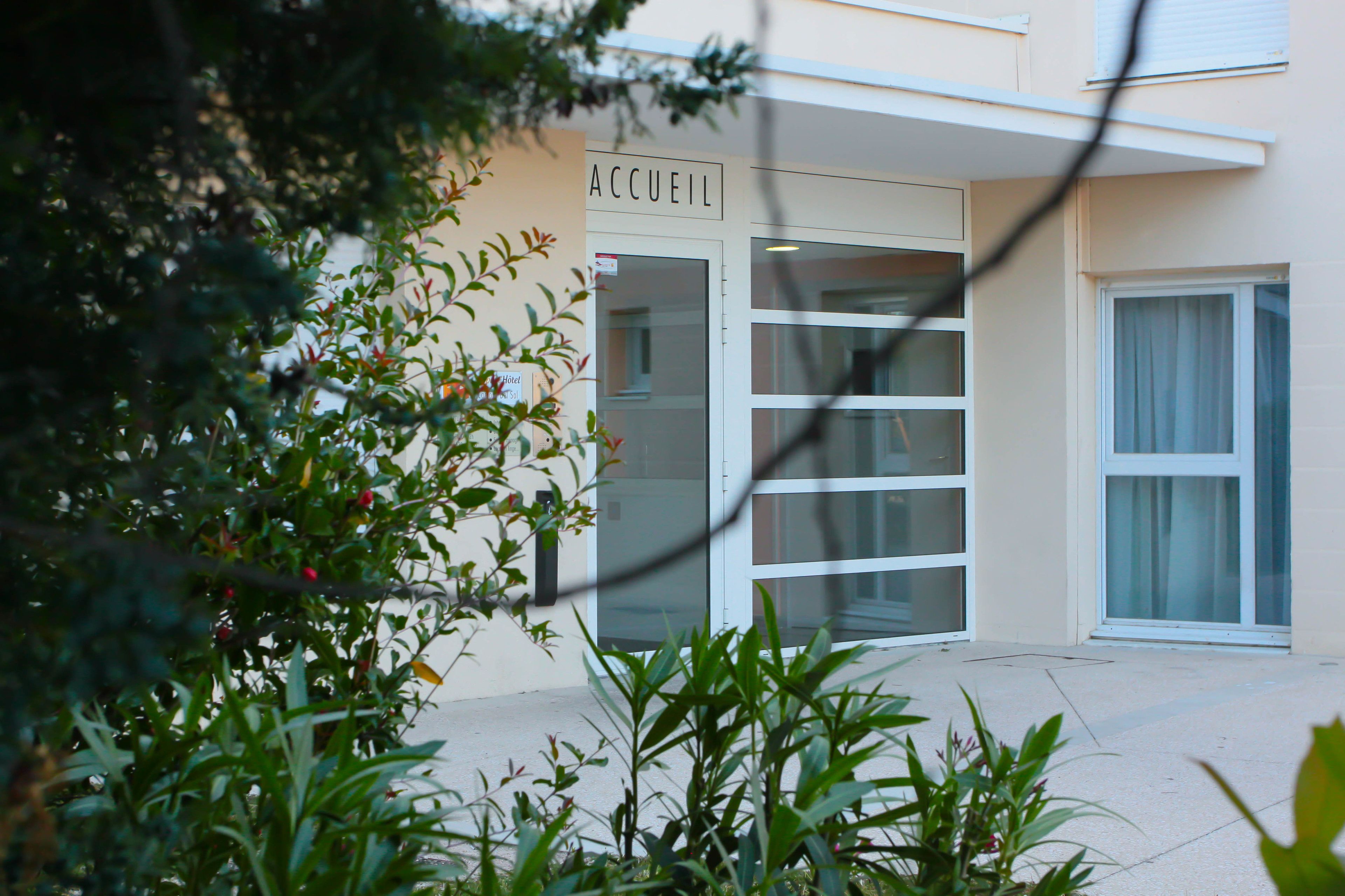 A building with a sign reading "ACCUEIL" indicating a reception area.