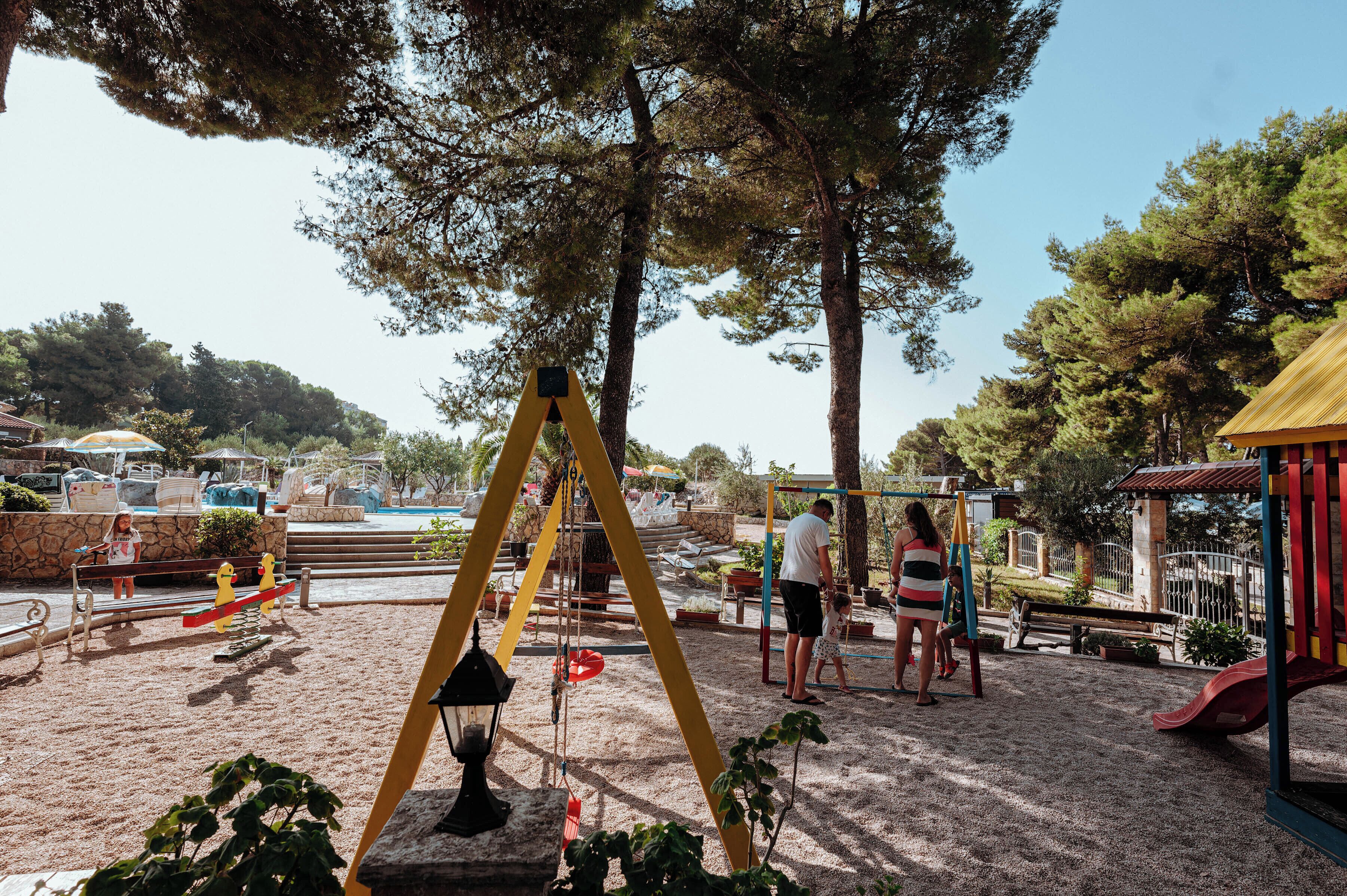 A playground with swings, slides, and a sandpit.