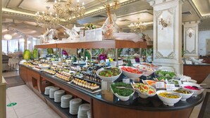 A buffet with various food items and a chandelier. - Hotel & SPA Diamant Residence - All Inclusive (Sunny Beach)