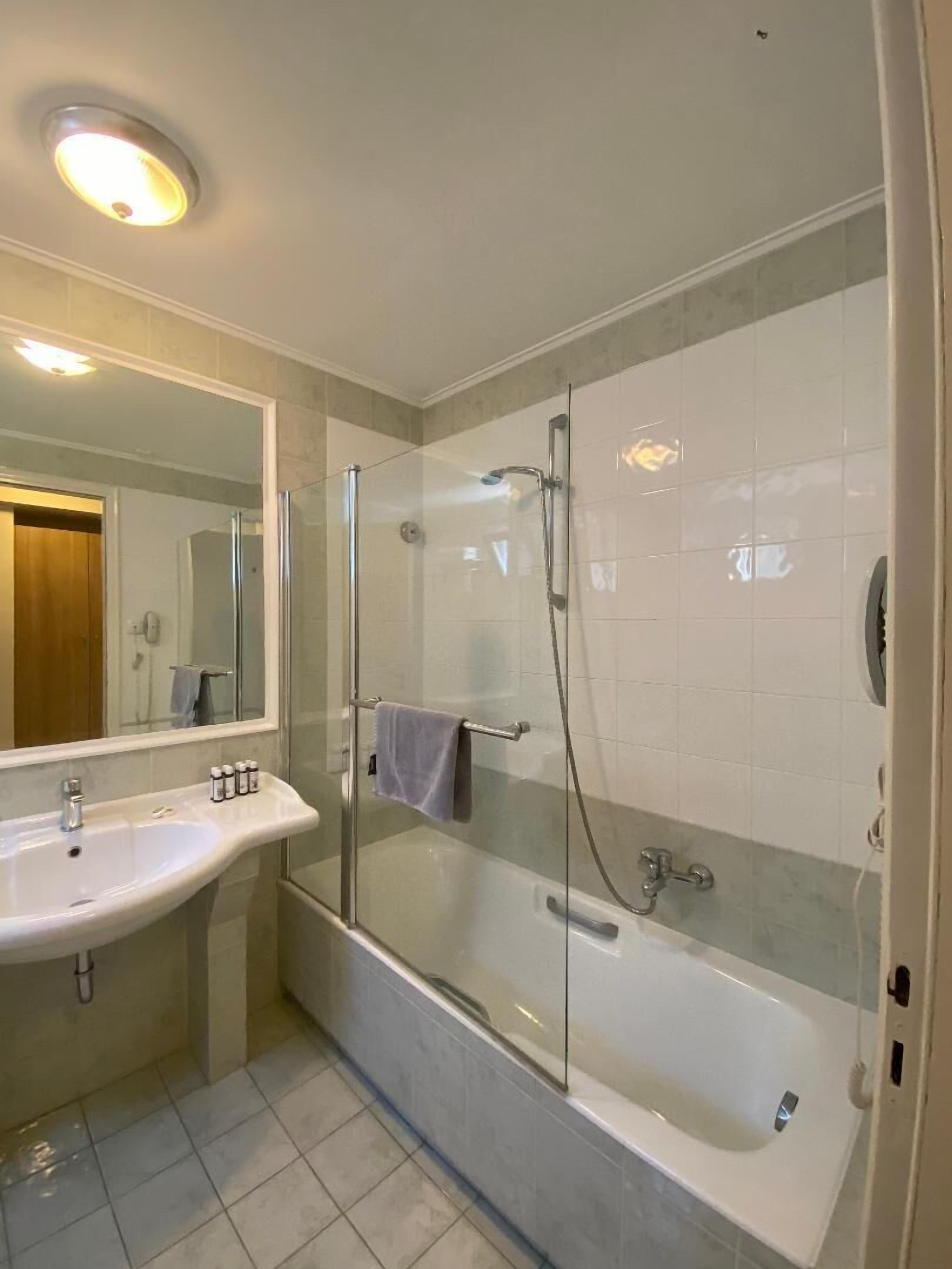 superior double room | bathroom | hair dryer, towels