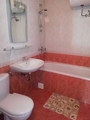 A bathroom with a toilet, sink, and bathtub. - Apart-hotel Efir (Sunny Beach)