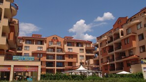 A multi-story residential building with balconies, a central courtyard, and a small pavilion. - Apart-hotel Efir (Sunny Beach)