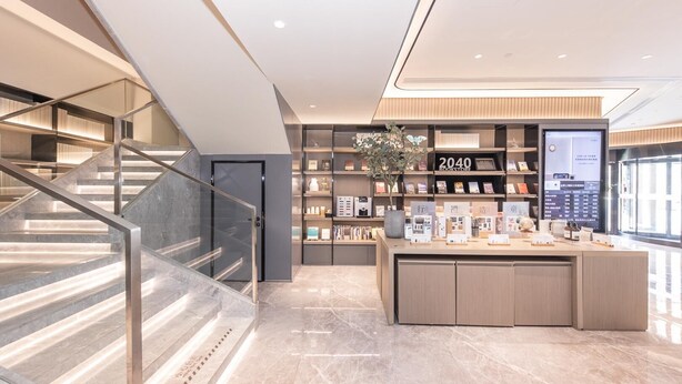 A modern bookstore interior with a staircase, marble flooring, and a digital display. - Ji Hotel (Shanghai)