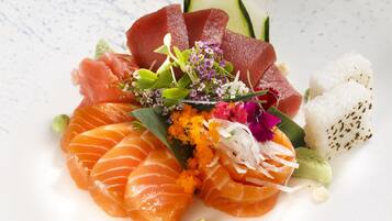 A plate of sushi with various toppings and garnishes.