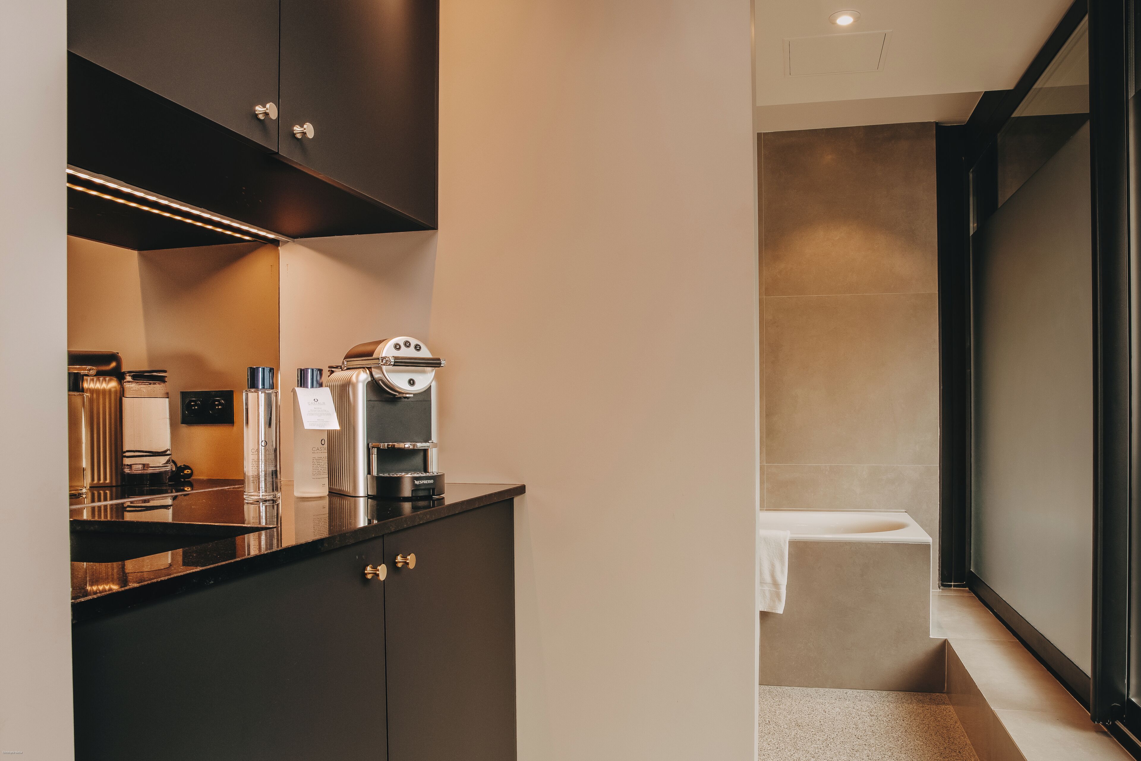 A modern bathroom with a bathtub, a toilet, and a sink.