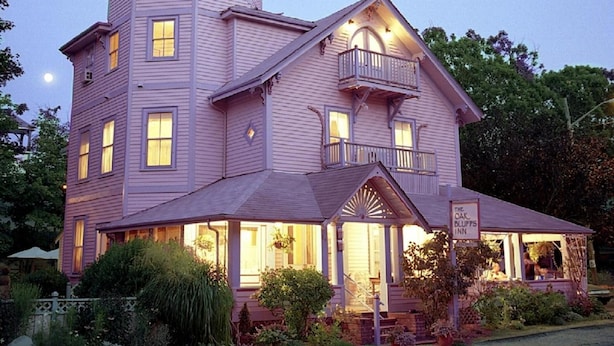 A large, multi-story building with a prominent tower and balcony, likely a hotel or inn. - The Oak Bluffs Inn (Oak Bluffs)