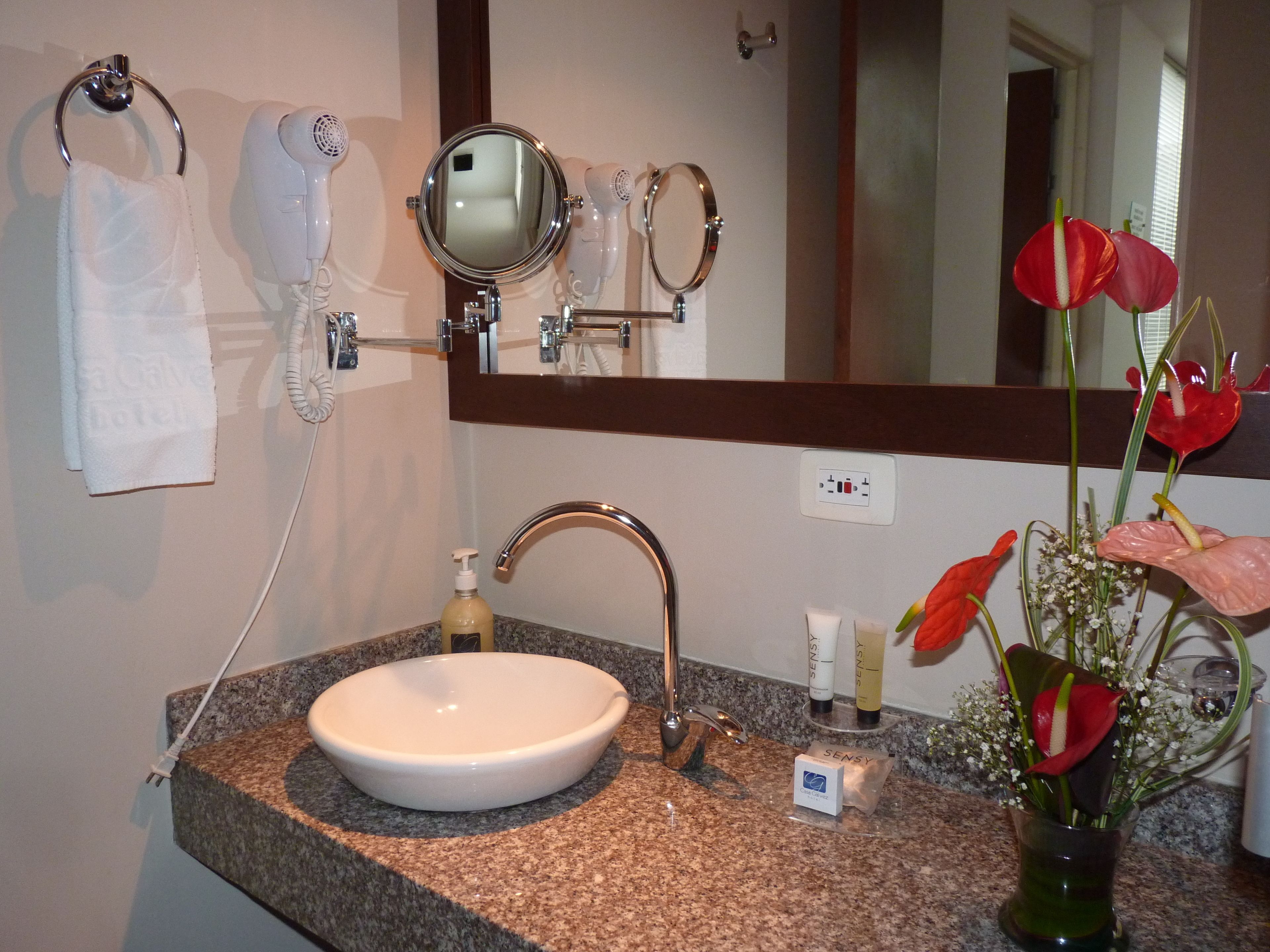 shower, hair dryer, slippers, towels