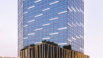 A tall, modern building with the 'ASCOOTT' sign at the top.