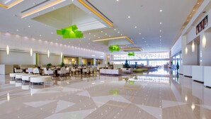 A spacious lobby with a polished floor, seating areas, and modern lighting fixtures. - Radisson Blu Resort, Jizan (Jizan)