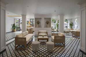 A spacious lobby with a patterned floor, multiple seating areas, and decorative plants. - Radisson Goa Candolim (Candolim)