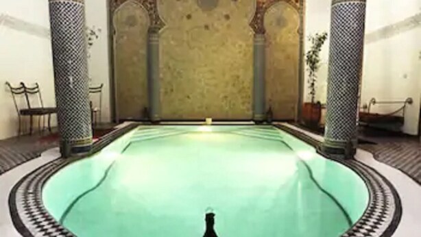 A large, ornate pool with intricate tile work around the edges. - Riad Jamaï (Fes)