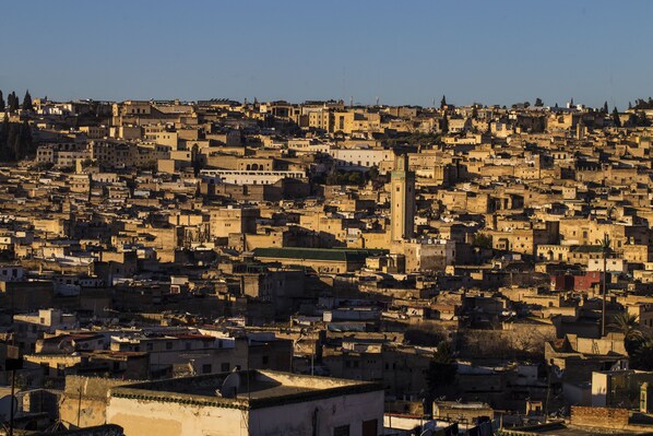 A densely packed urban area with numerous buildings and a prominent tower.