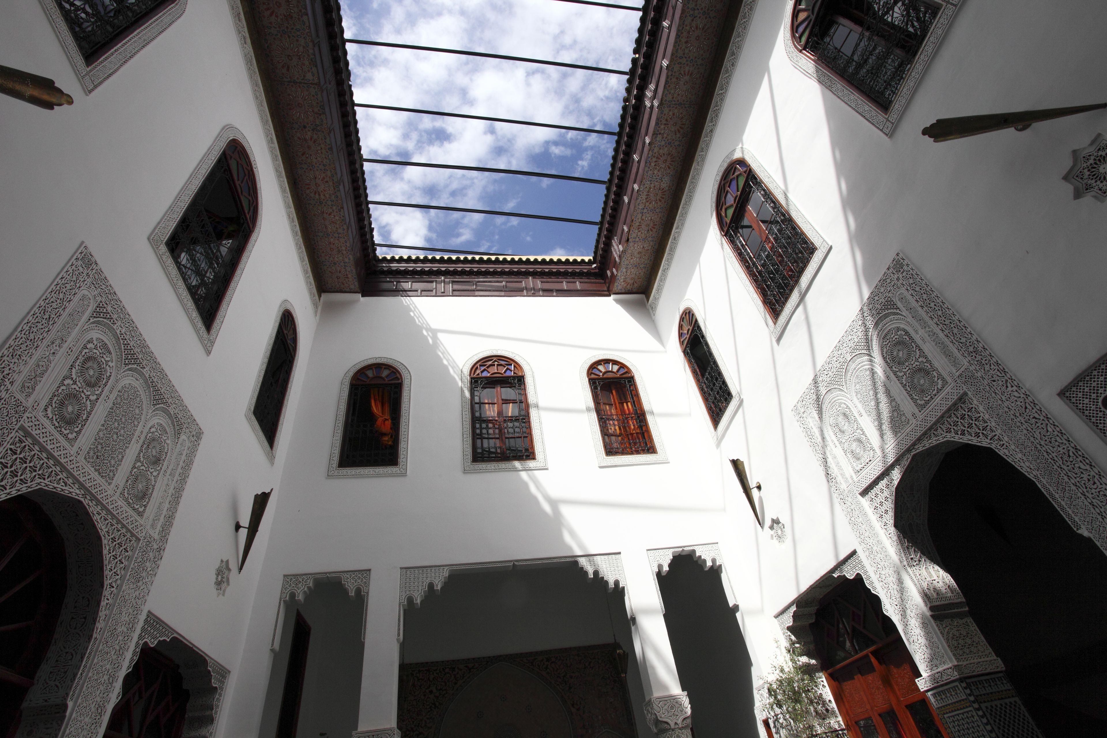 An interior courtyard with ornate arches and a skylight.