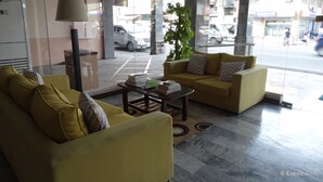 A modern lobby with yellow sofas, a coffee table, and a lamp. - GV Hotel Davao (Davao)