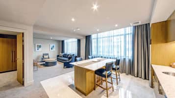 Junior Four Bedroom Suite | Living area | 50-inch flat-screen TV with cable channels, TV