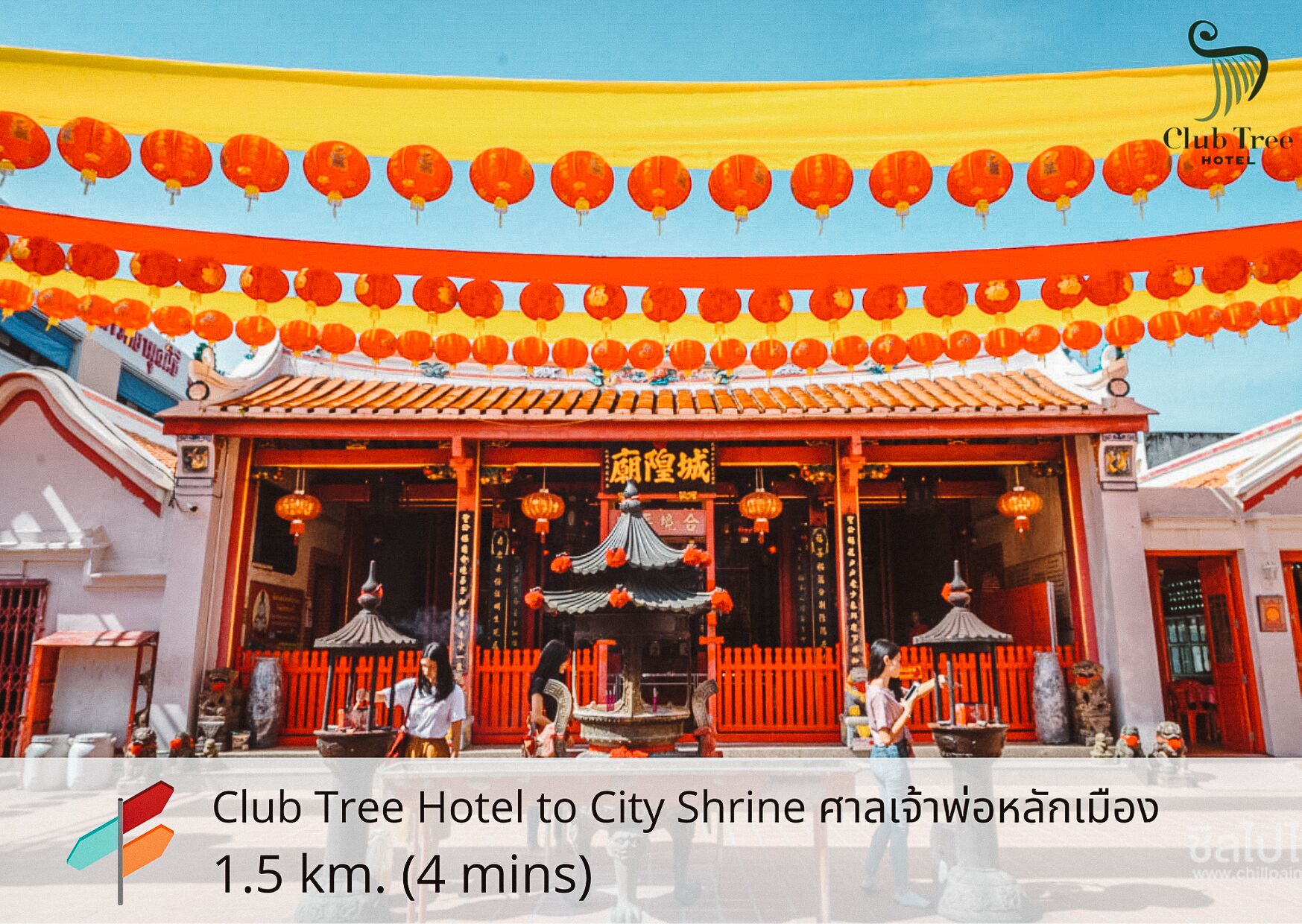 A traditional building with red and yellow decorations, including hanging lanterns.