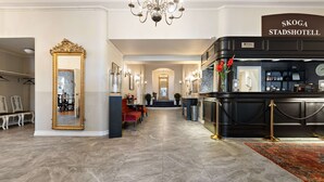 A hotel lobby with a grand mirror, a reception desk, and a chandelier. - Nora Stadshotell, Sure Hotel Collection by Best Western (Nora)