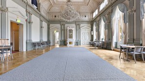 A spacious hall with a large grey carpet, wooden flooring, and a grand chandelier. - Nora Stadshotell, Sure Hotel Collection by Best Western (Nora)