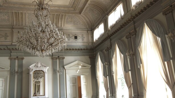 An ornate room with a large chandelier, classical columns, and large windows. - Nora Stadshotell, Sure Hotel Collection by Best Western (Nora)