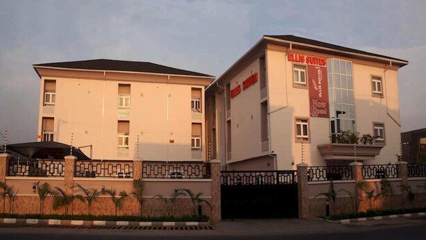 A hotel with a modern facade, a prominent Ellis Suites sign, and a gated entrance. - Ellis Suites Limited (Lagos)