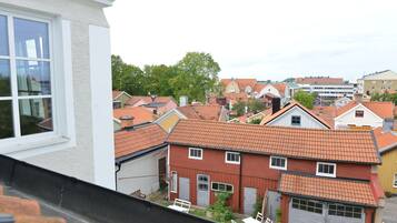 A residential area with houses featuring red-tiled roofs and white walls.