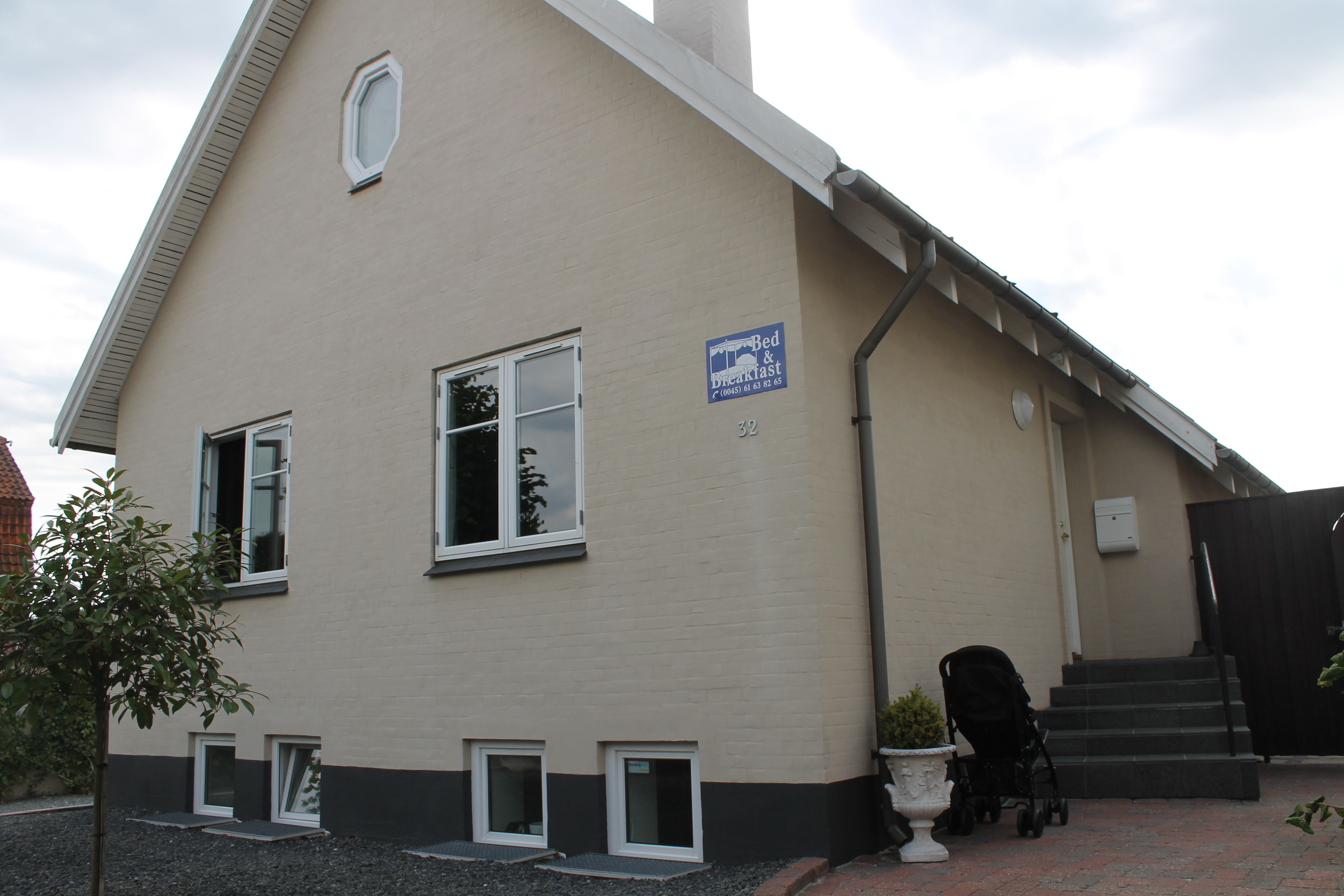 A two-story building with a sign indicating it is a bed and breakfast.