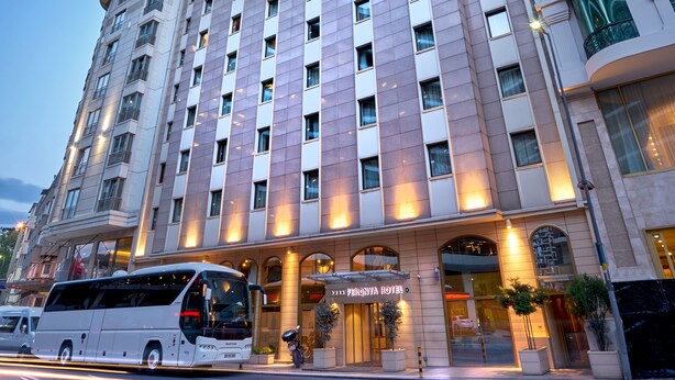 A multi-story hotel with a modern facade, large windows, and a prominent entrance. - Feronya Hotel (Istanbul)