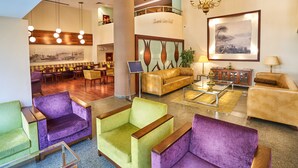 A lobby with a seating area, a bar, and a staircase. - Feronya Hotel (Istanbul)
