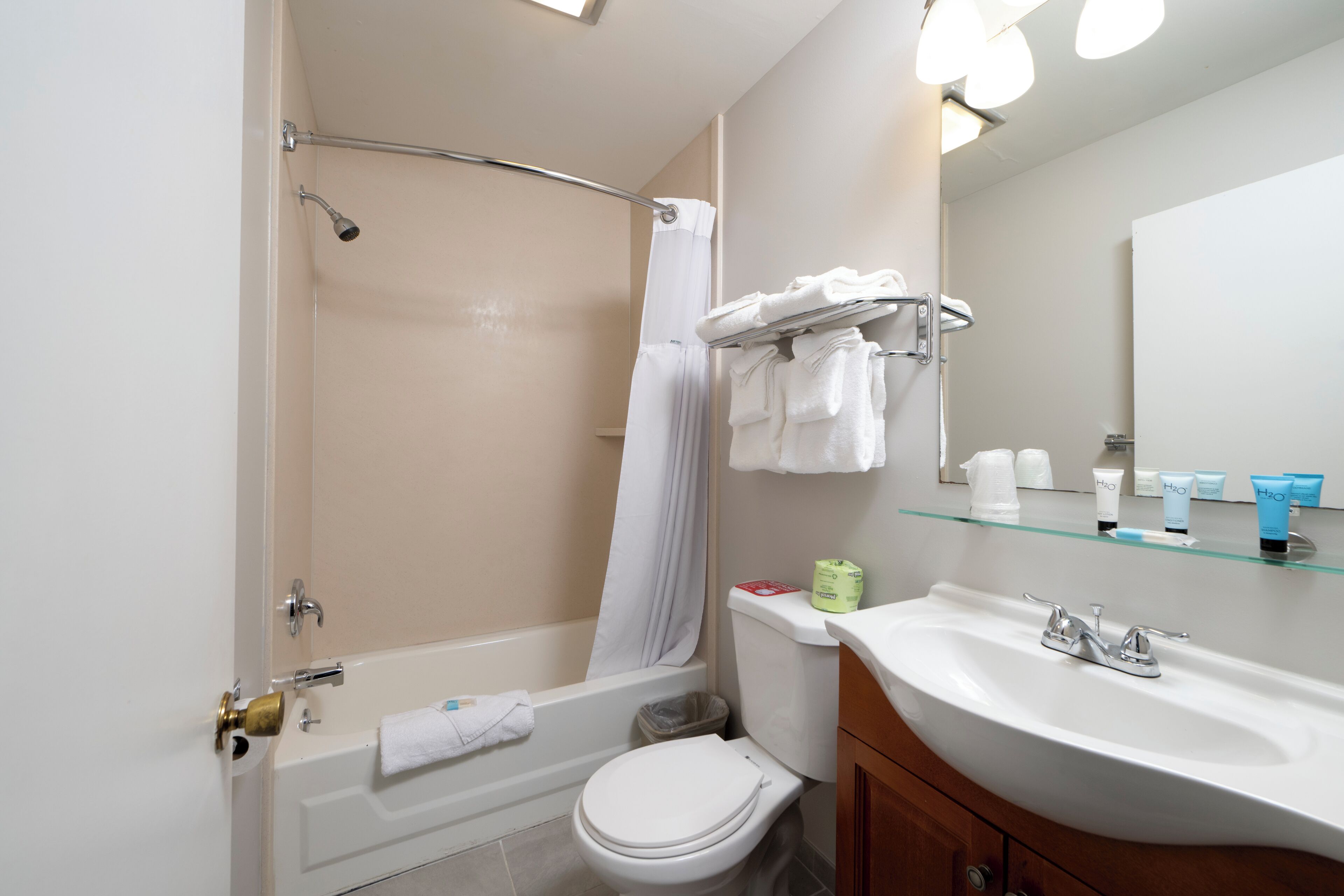 A bathroom with a bathtub, toilet, and sink.