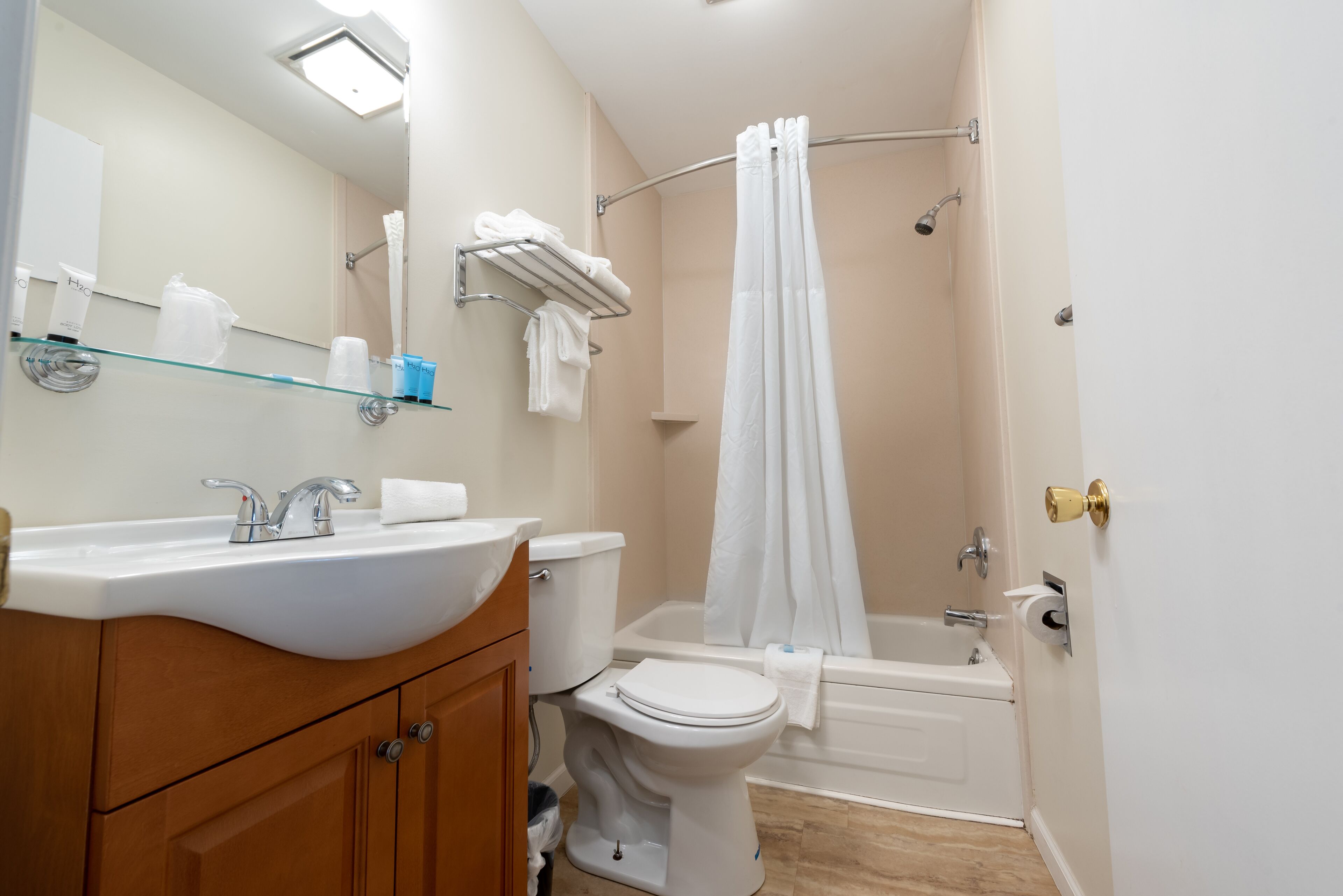 A bathroom with a sink, toilet, and bathtub.