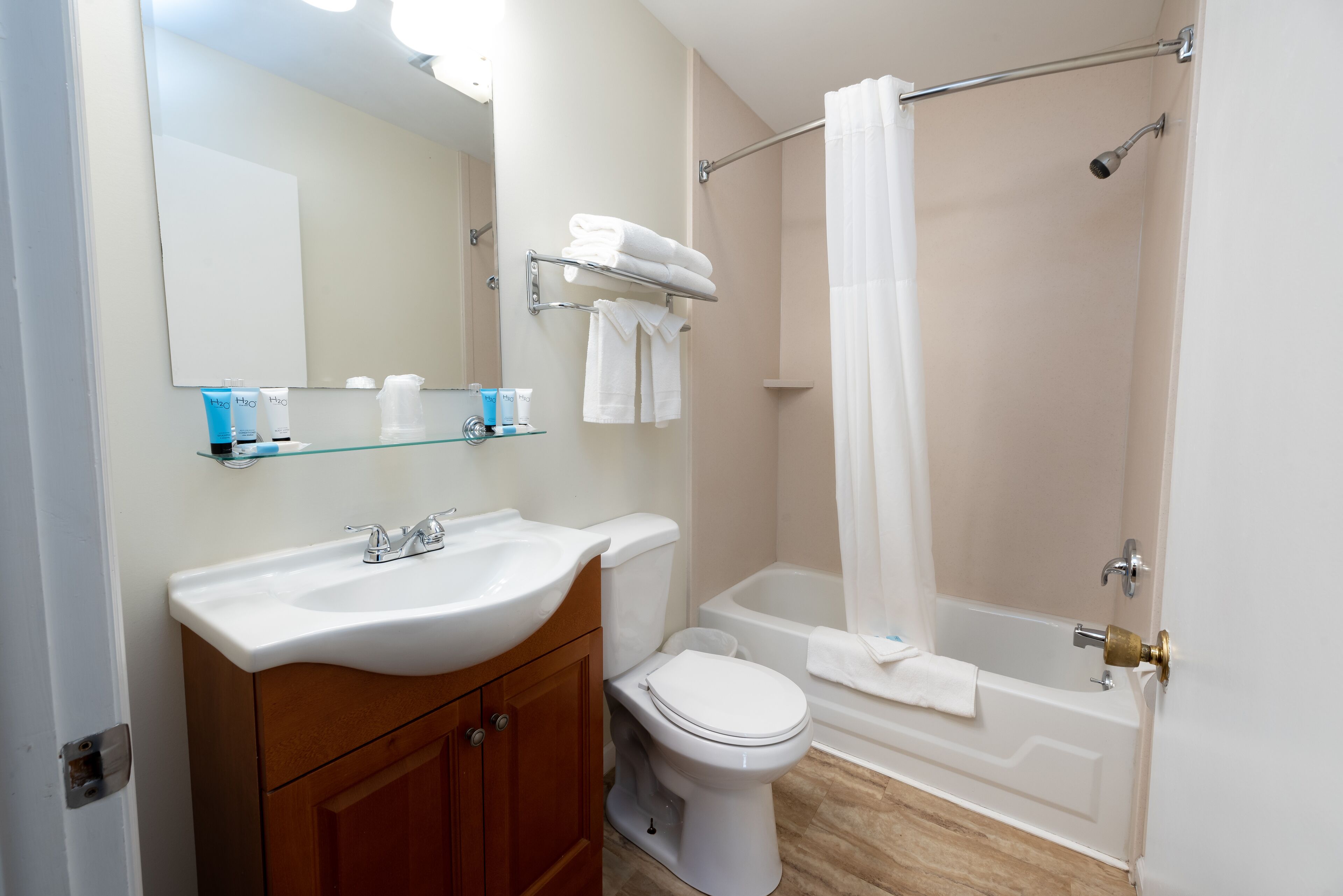 A bathroom with a sink, toilet, and bathtub.