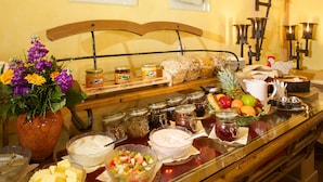 A breakfast buffet with various food items and condiments.